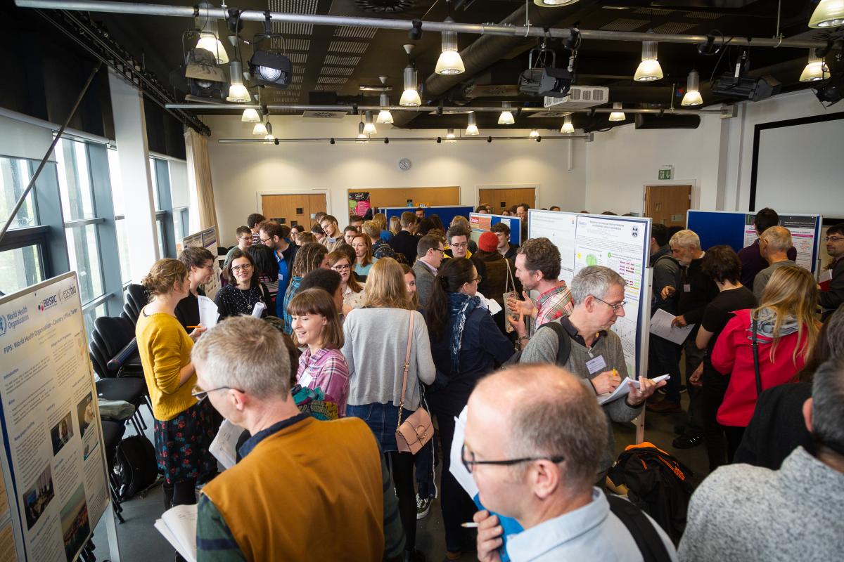 Photo with lots of people taking part in a poster session at the 2019 EASTBIO Symposium