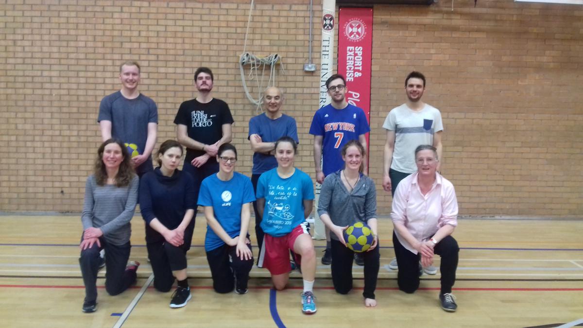 Members of the welburn and Okhura lab pose for a photo in a sports hall