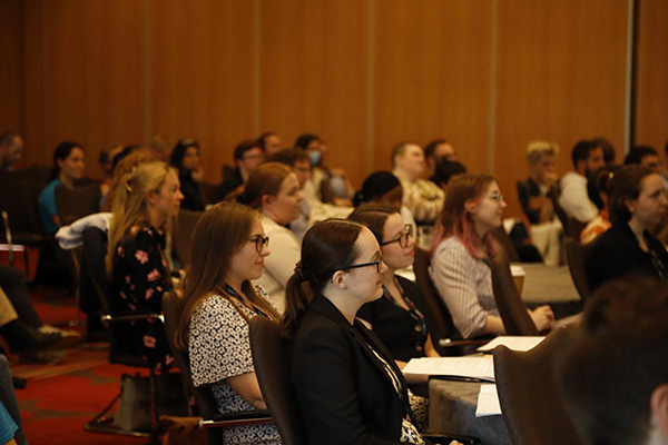 A group of students sit looking towards the front of room for a workshop