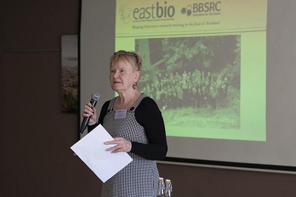 Photo of Bernadette Conolly speaking in front of a screen