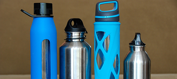 Photo of 4 water bottles lined up, 2 metal and 2 blue plastic