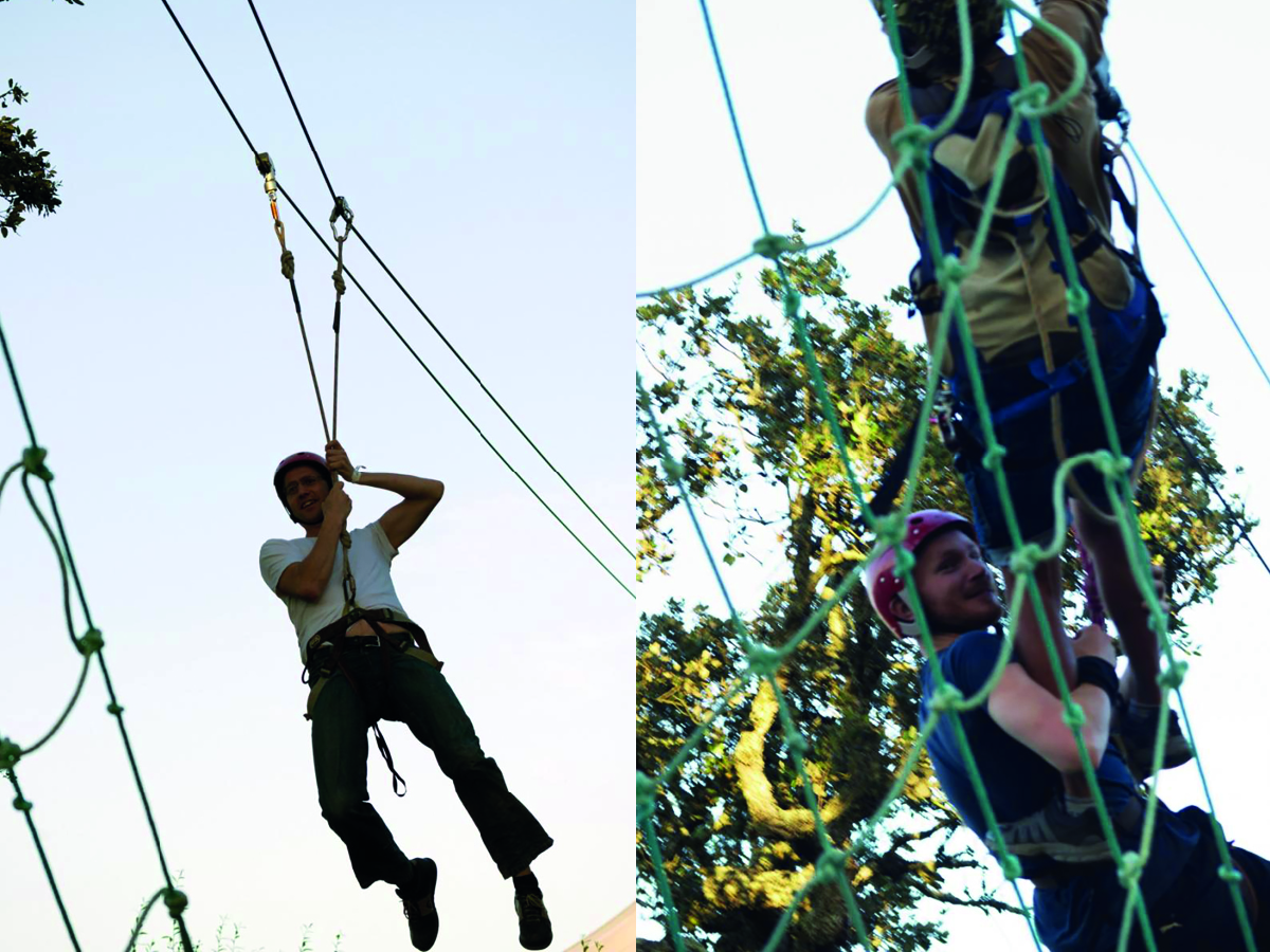 Two lab group members climbing netting