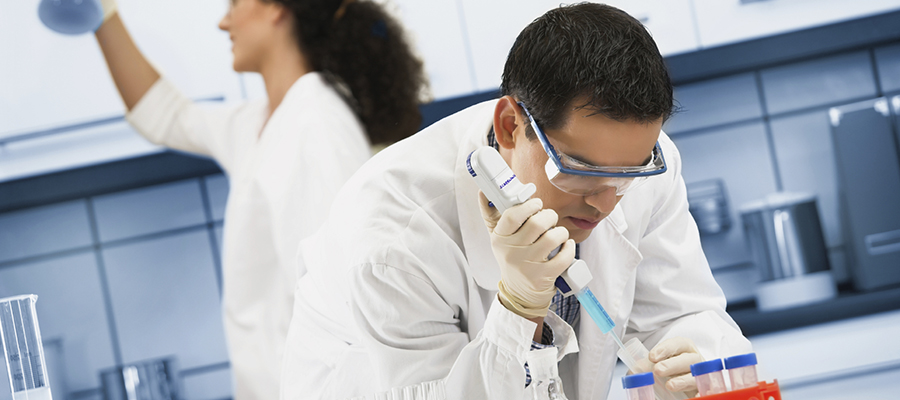 Two lab scientists in white coats