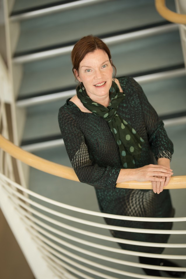 Photo of Dr Fiona M. Mitchell standing on a staircase