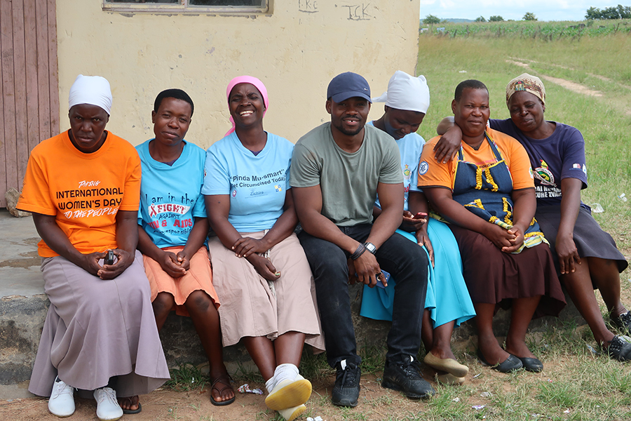 Photo of Derick Nii Mensah Osakunor outside building with group of project workers