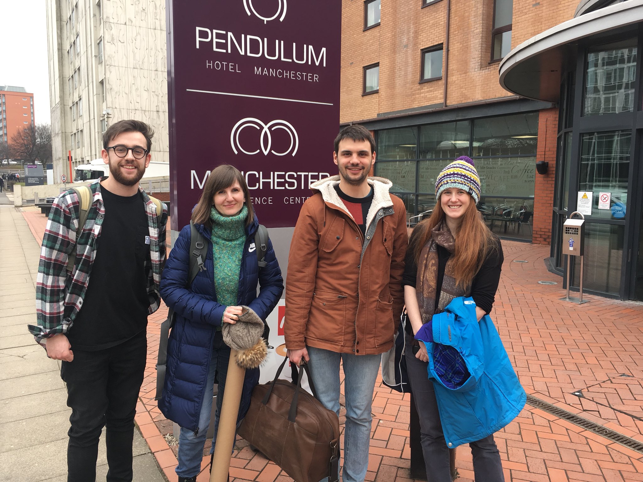 Four members of the lab pose for a photo outside the Dynamic Cell conference