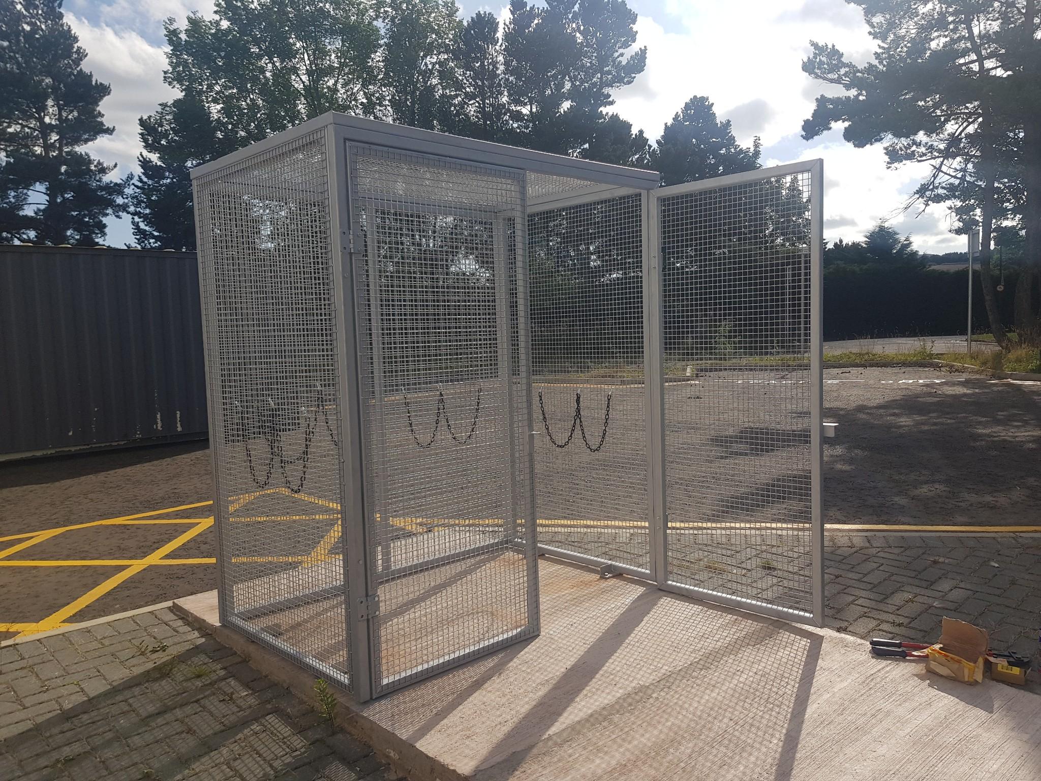 Photo of the finished gas cylinder cage in place, outside on a sunny day