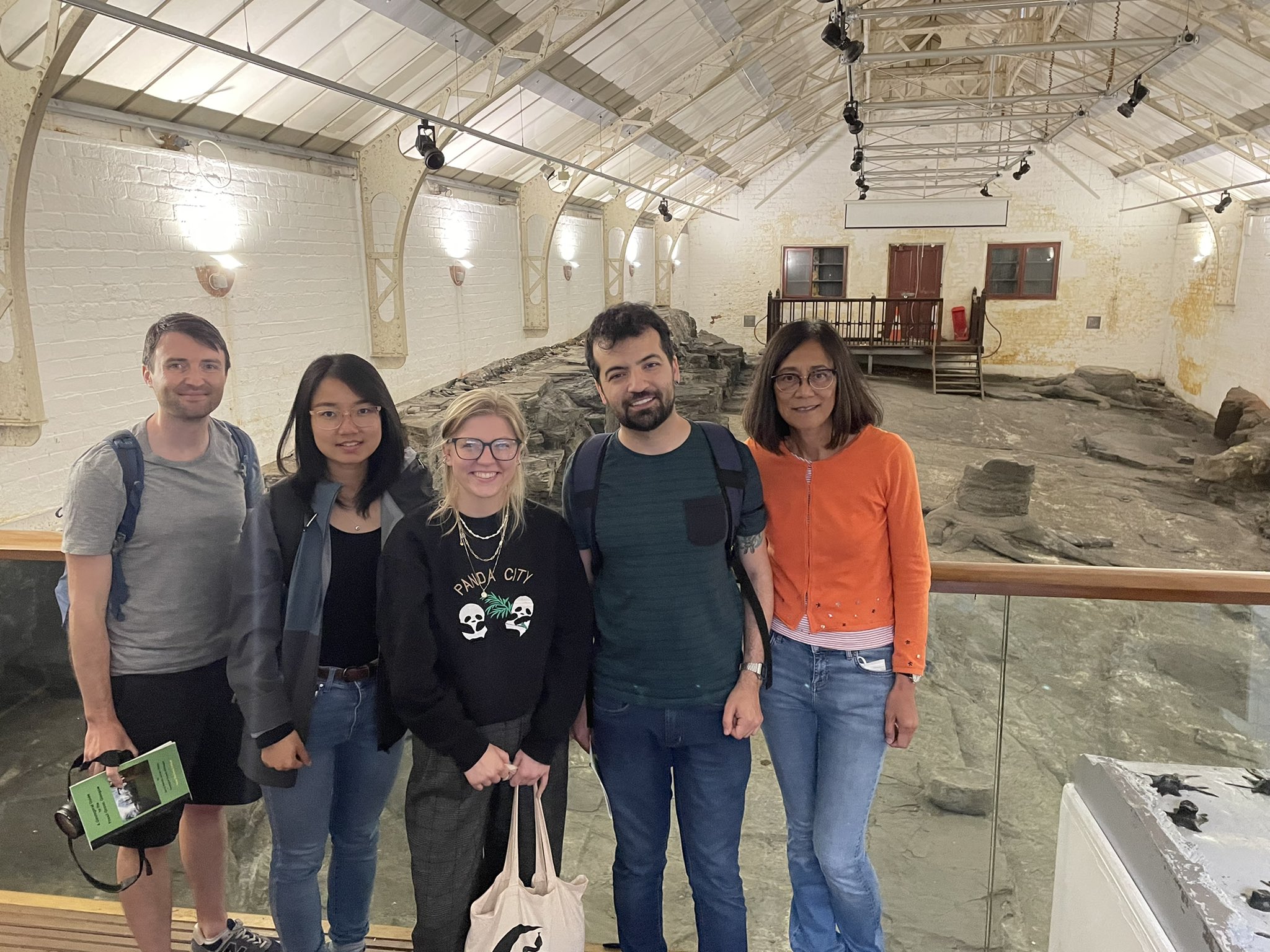 Group photo of five members of the Hetherington lab at the fossil grove fossil site in Glasgow