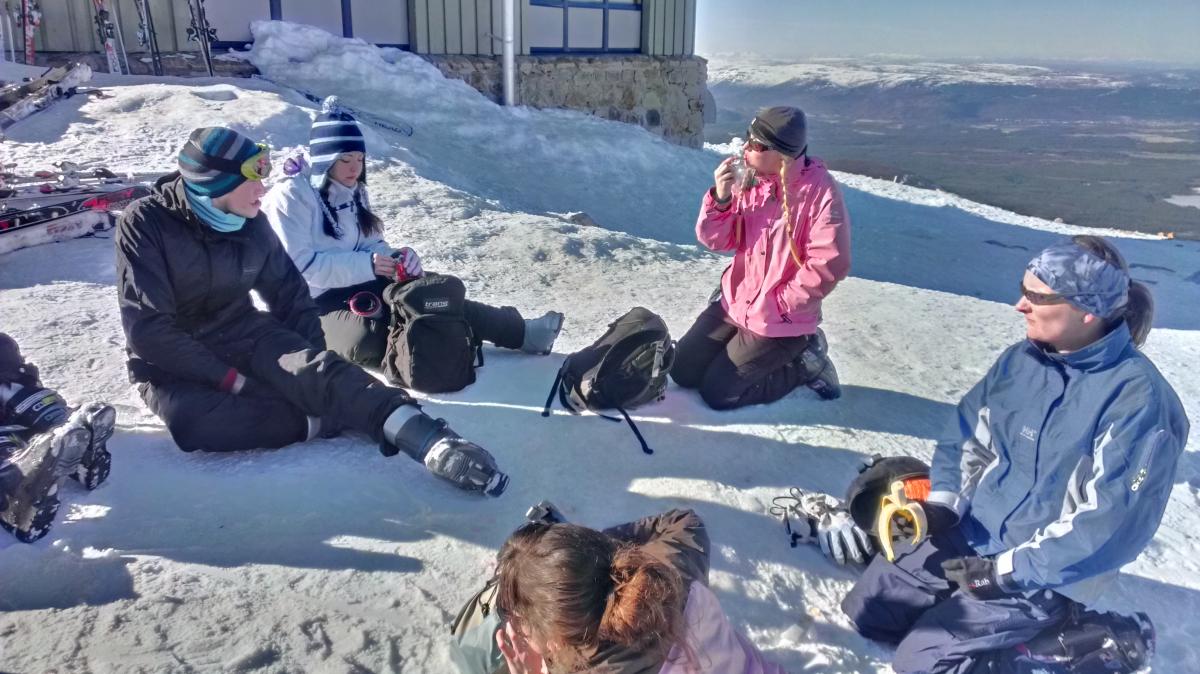 Photo of some group members sitting in the snow