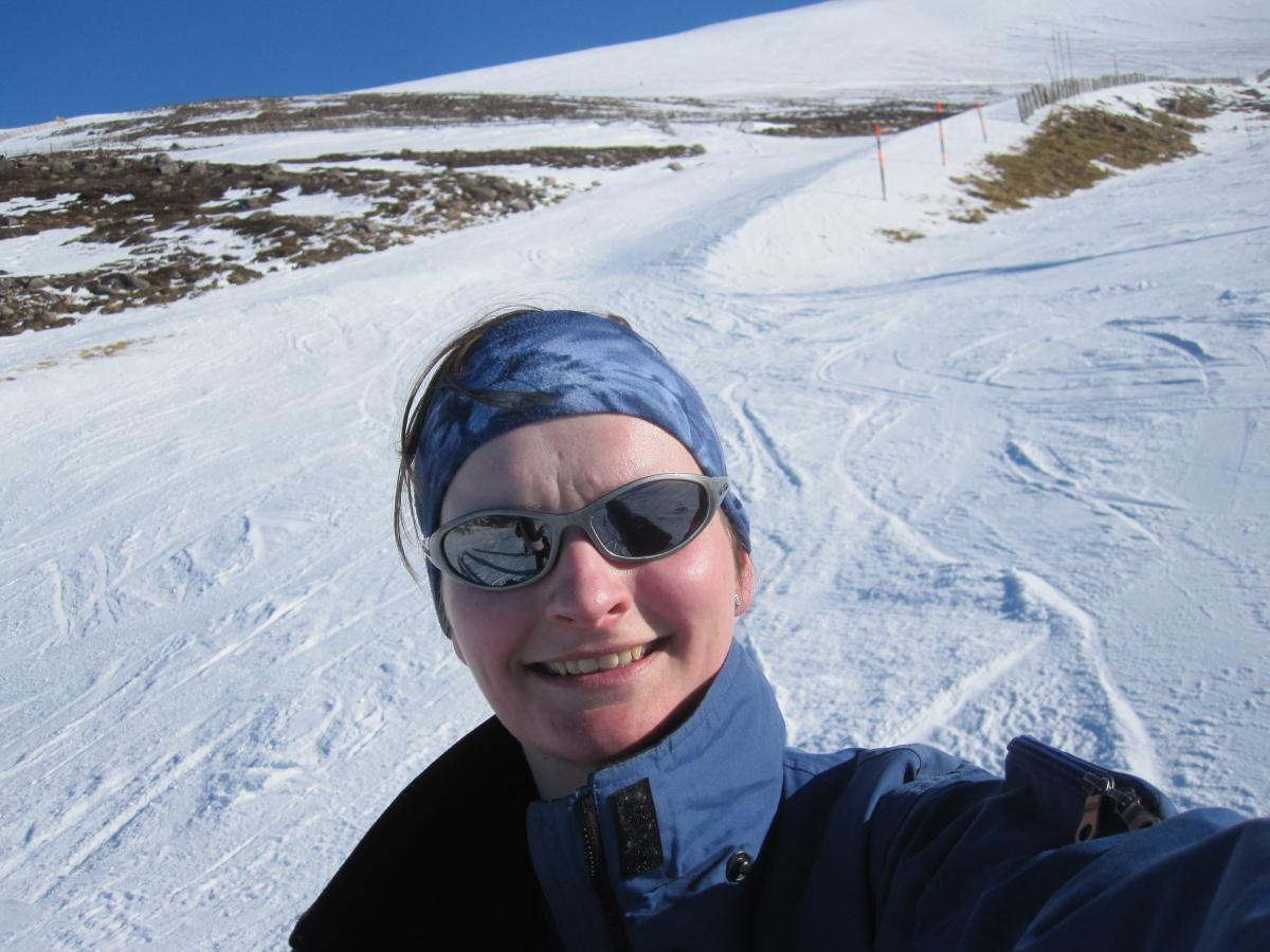 A selfie of Julie Blyth on the slope, in ski suit and sunglasses