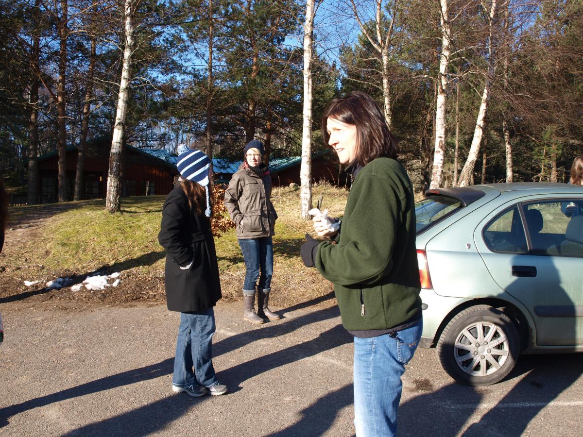 Lab members in the car park, with cars and trees nearby