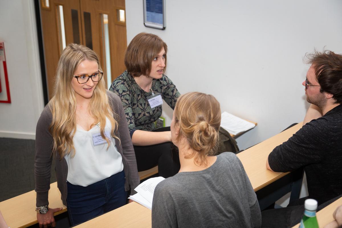 Photo of 4 students taking part in a Science pub quizz snapshot at the 2019 Symposium