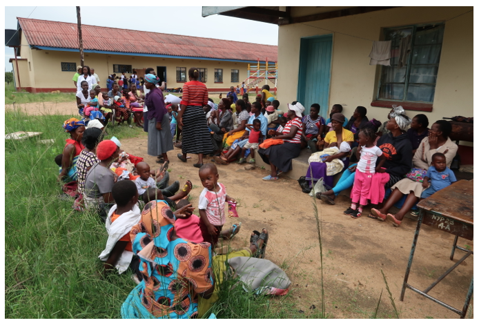 Villagers gathered outside building