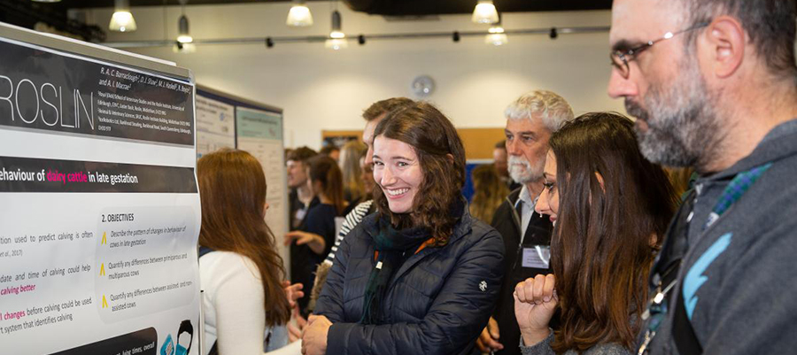 Students presnt their posters at a poster session