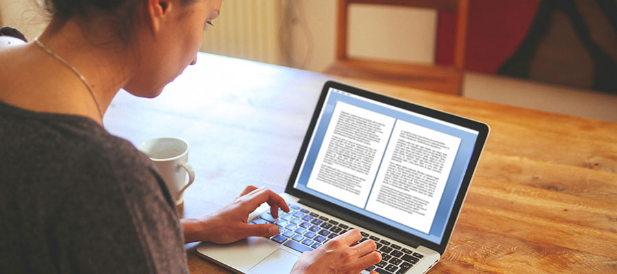 Photo of a female student working on a laptop