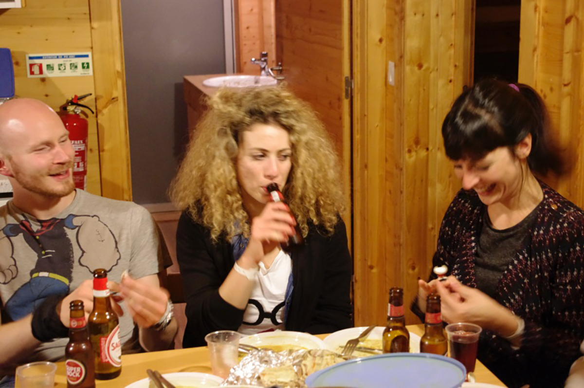 Three lab group members sat around a table socialising